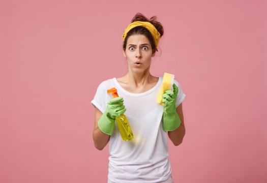 Woman looking stressed holding sponges