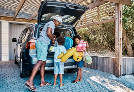A family packing the car to leave for summer vacation | Merry Maids