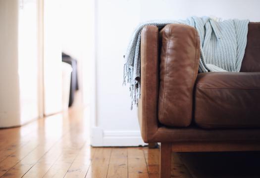Couch sitting on clean hardwood floors
