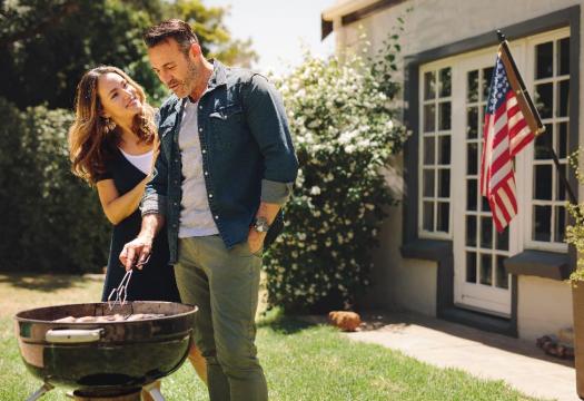 Husband and Wife Grilling with American Flag