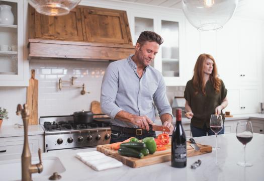 Husband and Wife Cooking Meal Together